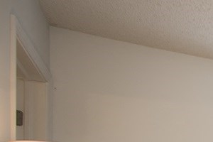 a bedroom with a bed and a dresser and a window
